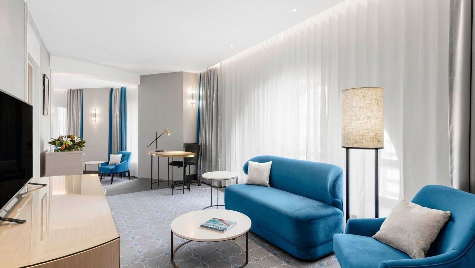 Deluxe room with king bed, lounge corner, and premium furnishings